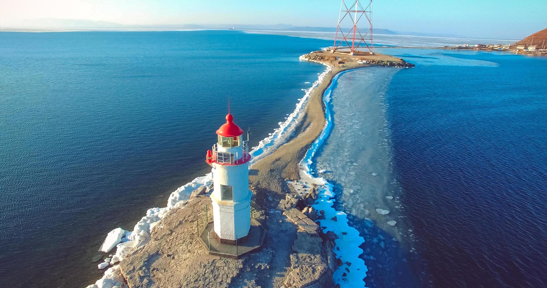 Aerial photography Tokarev lighthouse on the background of the blue sea. photo