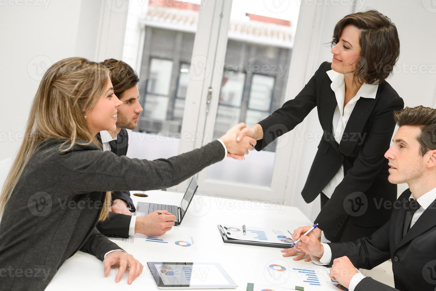 Business people shaking hands, finishing up a meeting photo