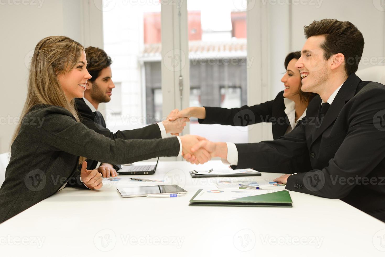 Business people shaking hands, finishing up a meeting photo