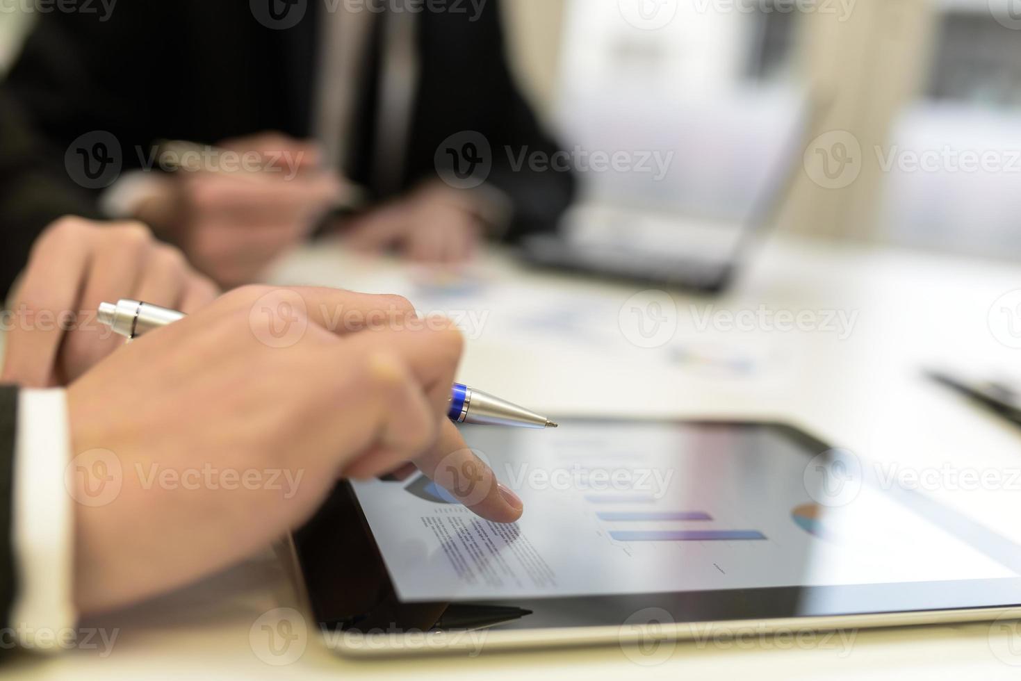 Business team using tablet computer to work with financial data photo