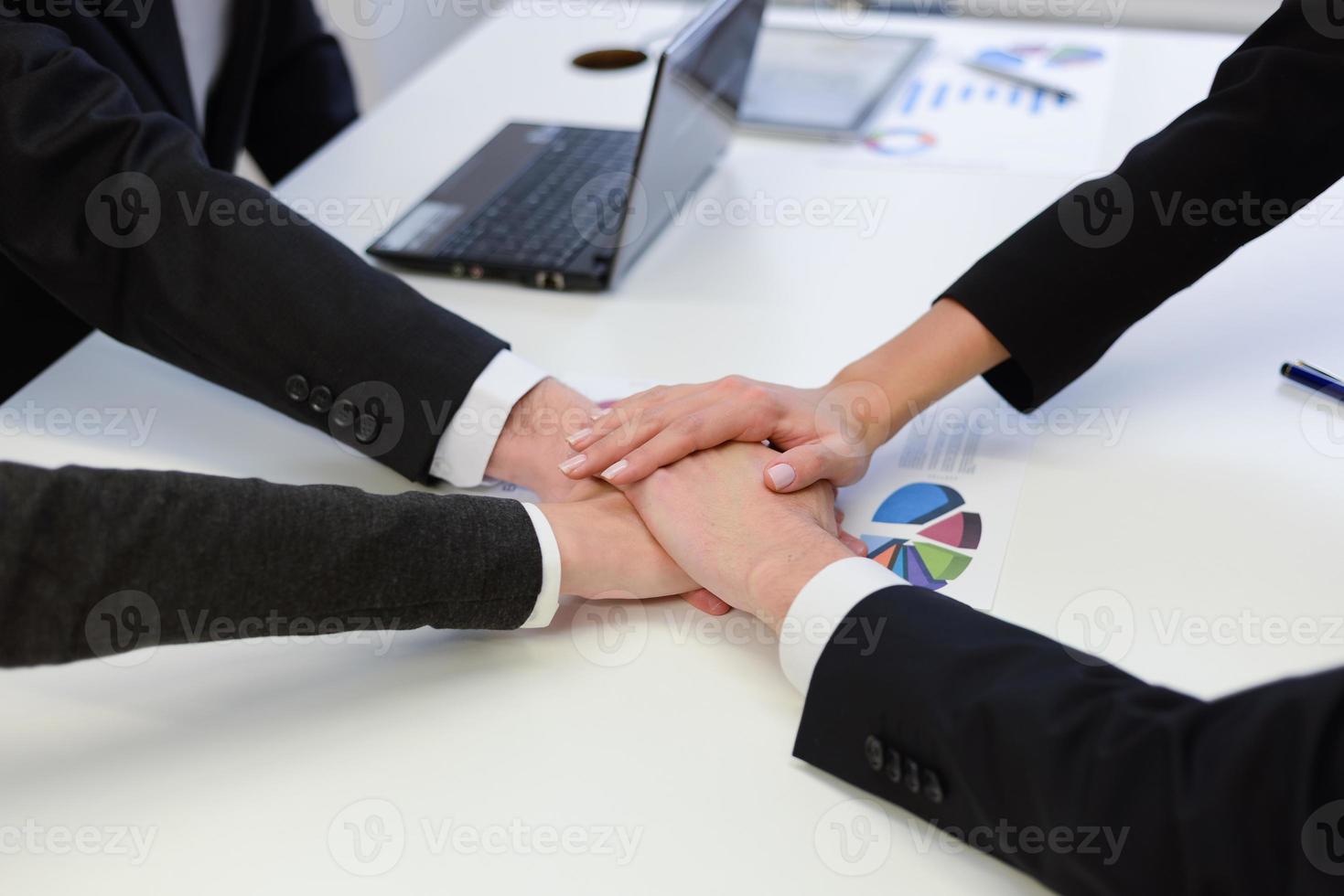 Business team with their hands together photo