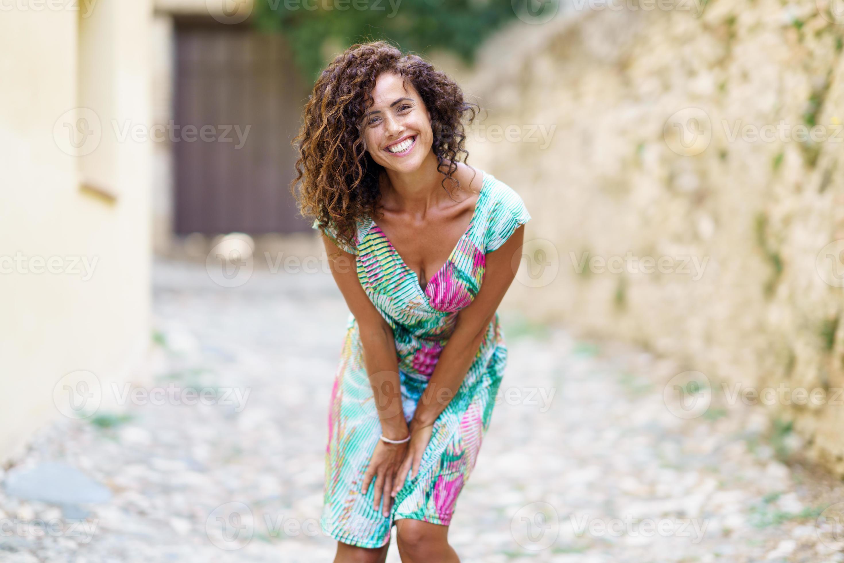 Beautiful brunette middle-aged woman wearing spring colorful dress