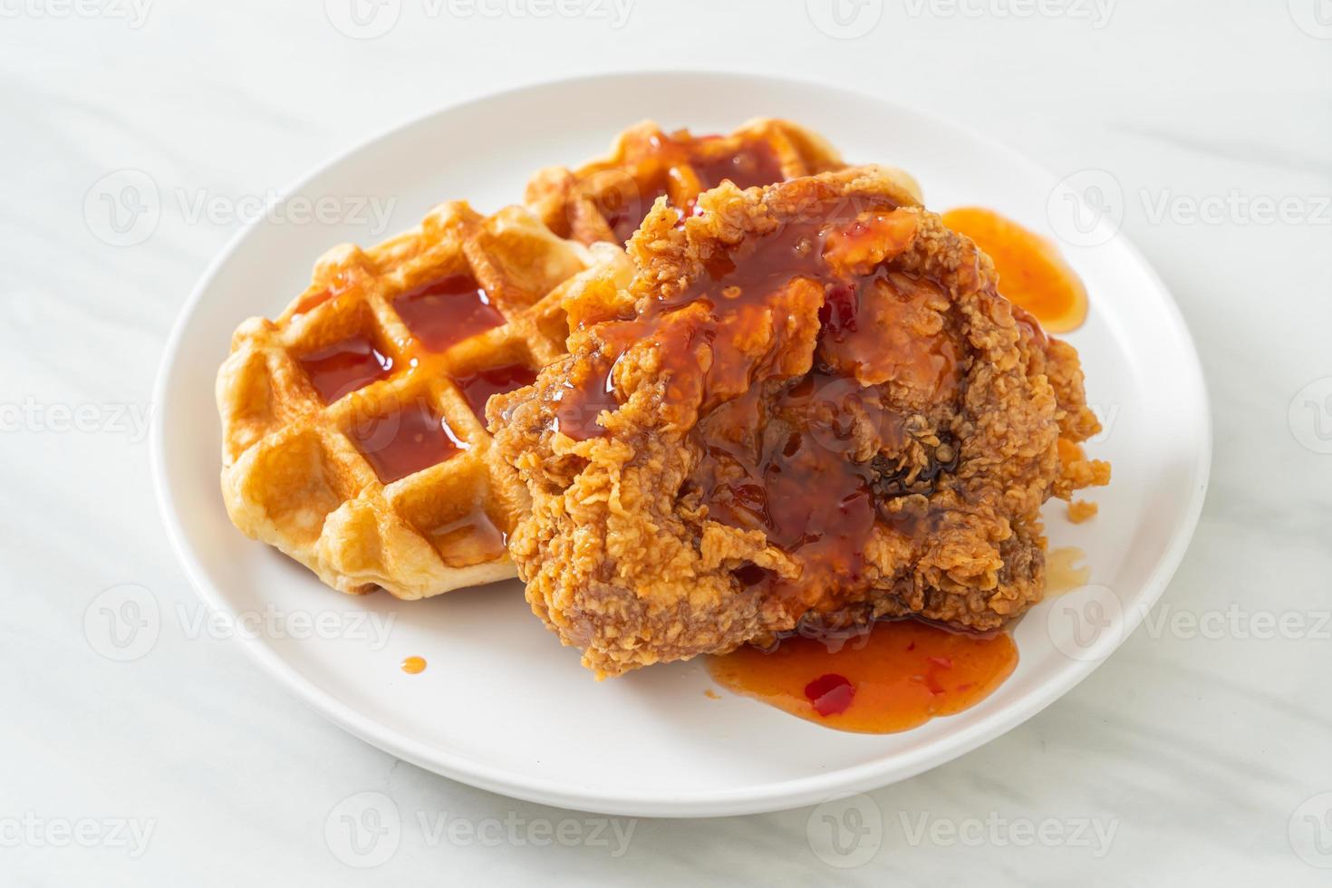 fried chicken with waffle and spicy sauce photo