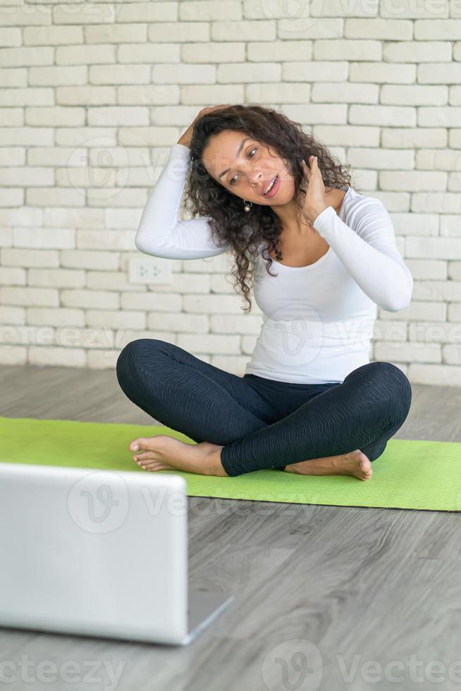 Latin woman teaching yoga online photo