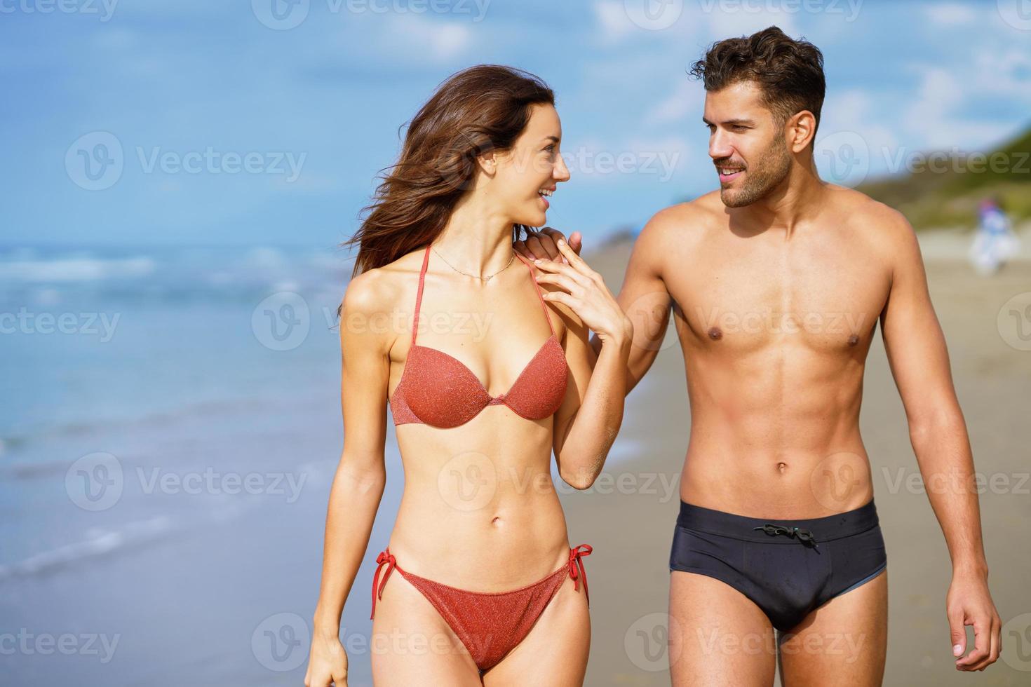 Young couple of beautiful athletic bodies walking together on the beach 4242171 Stock Photo at Vecteezy