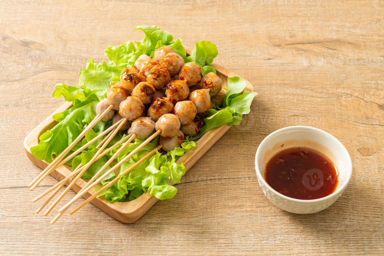 grilled meatballs skewer with spicy sauce photo