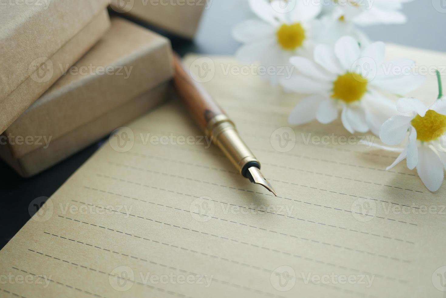 envelope , empty paper and fountain pen on table photo