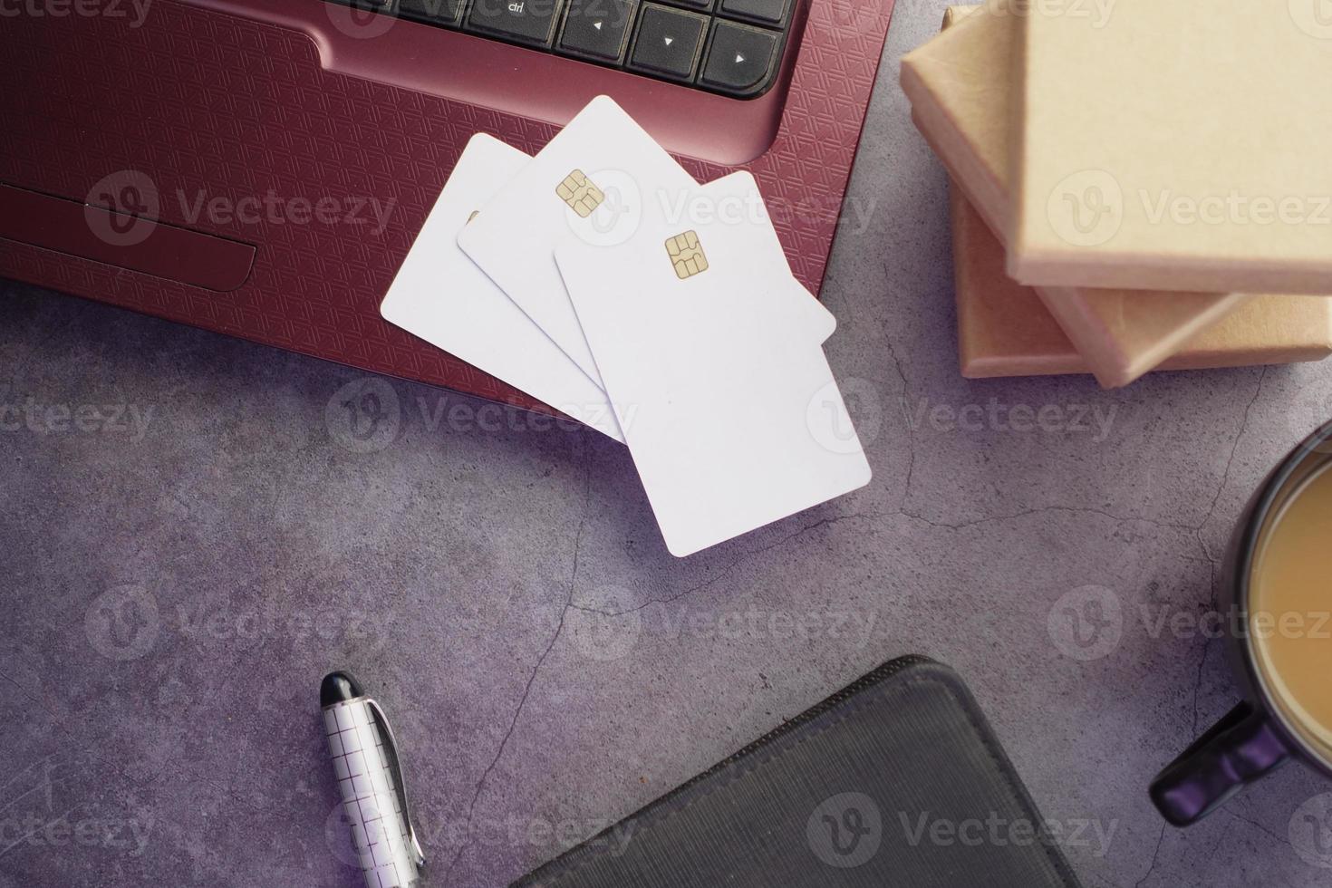 high angle view of credit cards on laptop on table photo