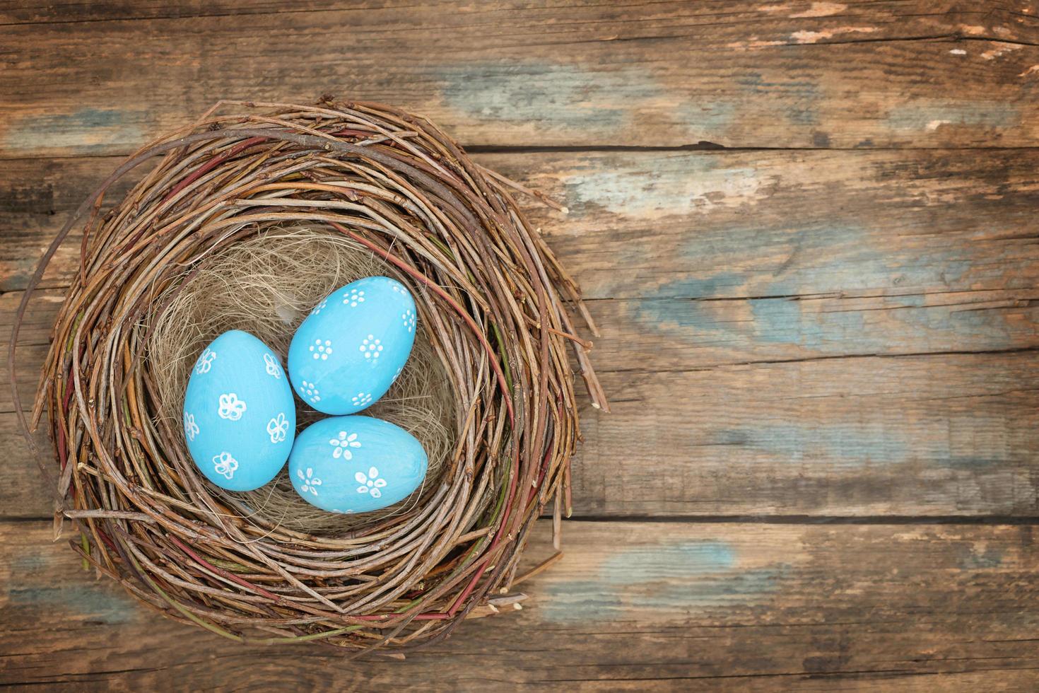 Painted easter eggs arranged in a row on a wooden background photo