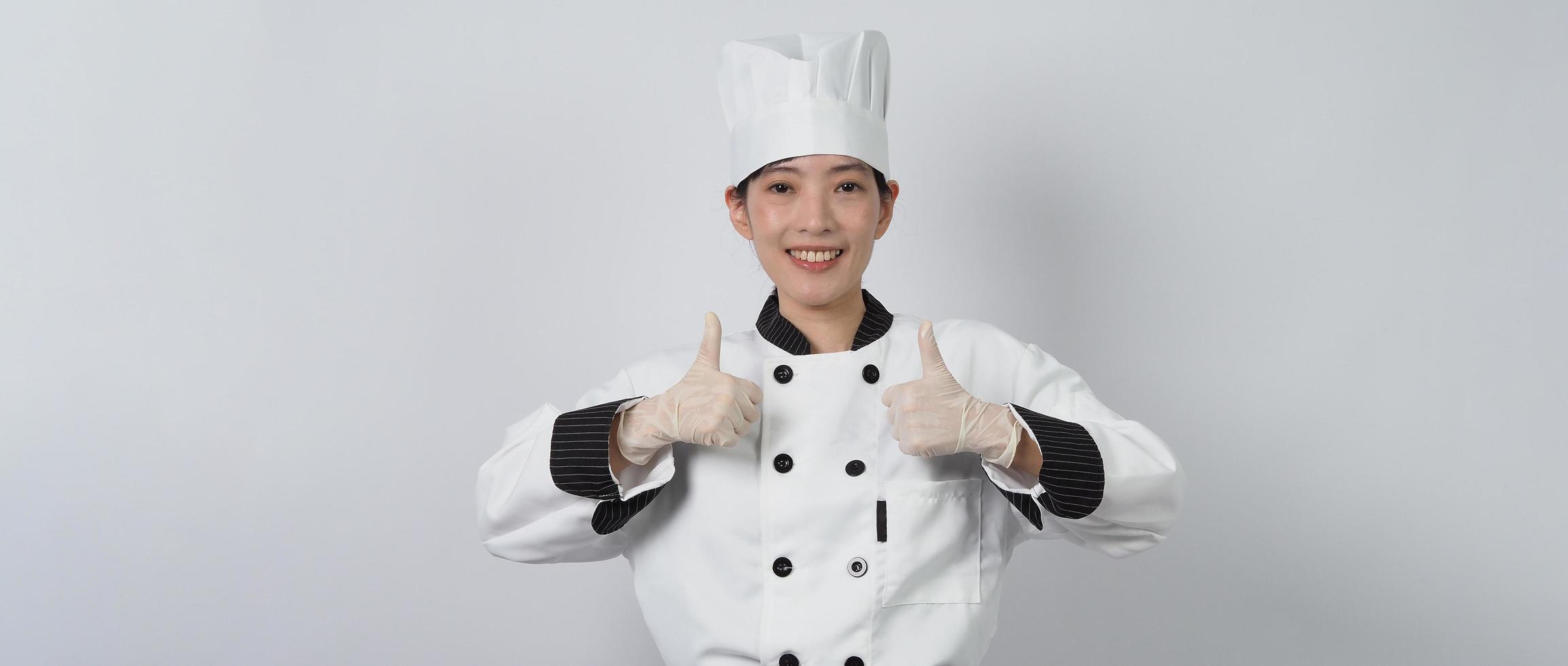 Asian woman chef holding smartphone or digital tablet and received order from online photo