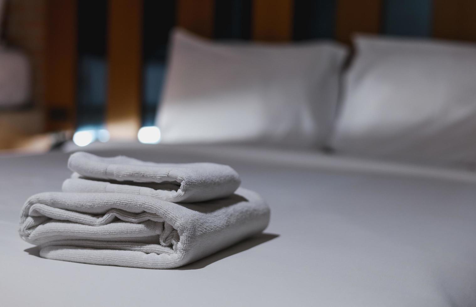 The towels are folded and placed on the bed for the hotel guests. photo
