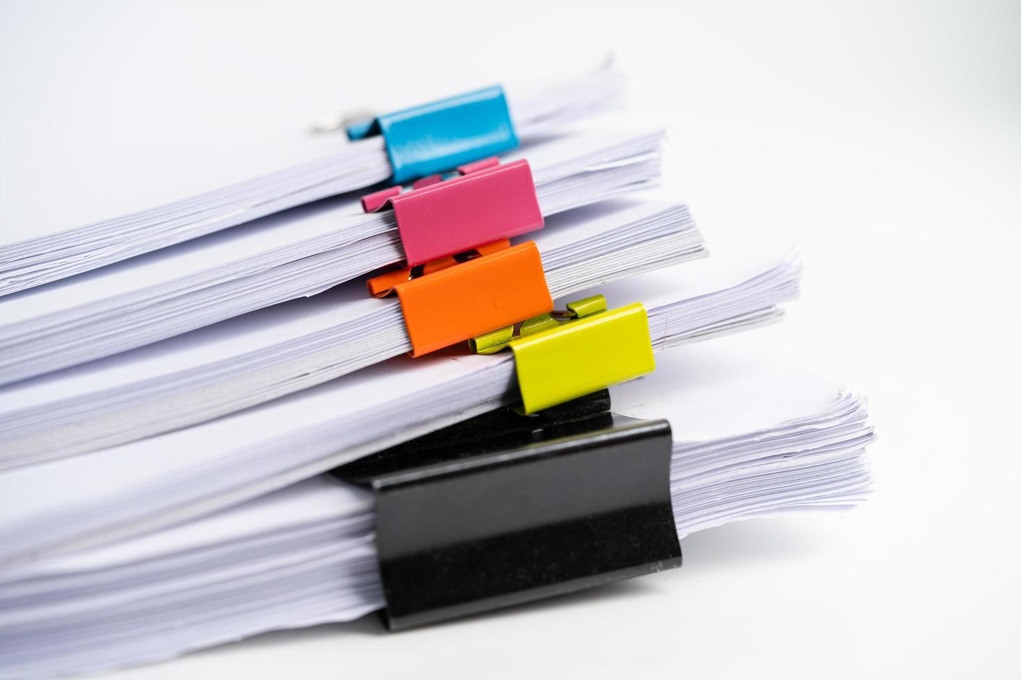 Stack of report paper files in business office clips. photo