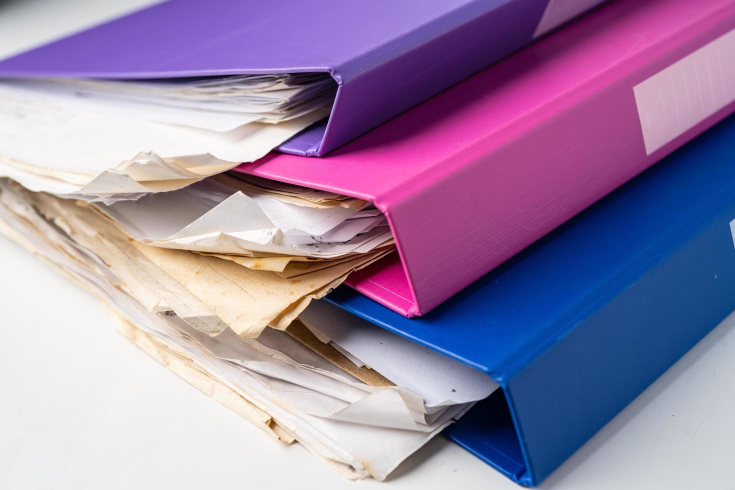 File Folder Binder stack of multi color on table in office. photo