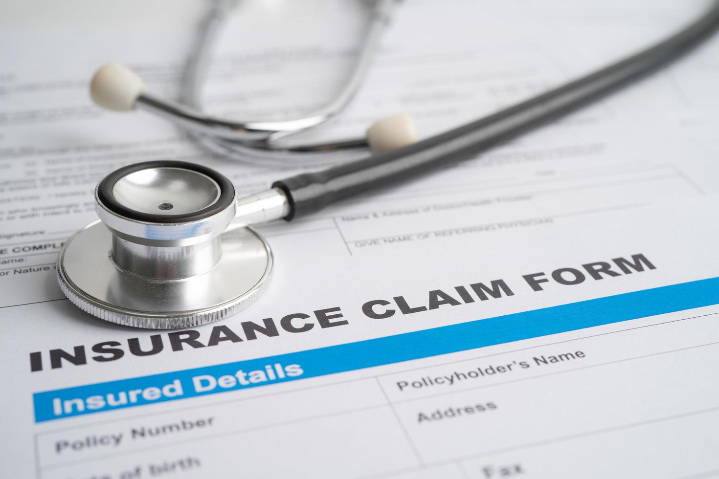 Stethoscope on Insurance  claim accident car form, Car loan, insurance and leasing time concepts. photo