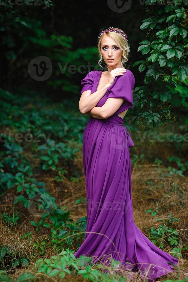 Girl model blonde in a lilac dress with a bouquet photo