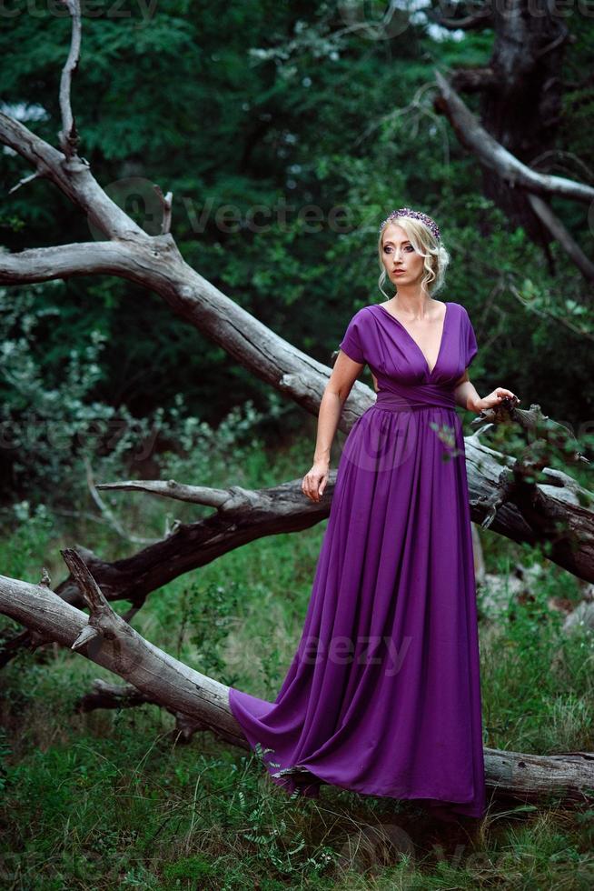 Girl model blonde in a lilac dress with a bouquet photo