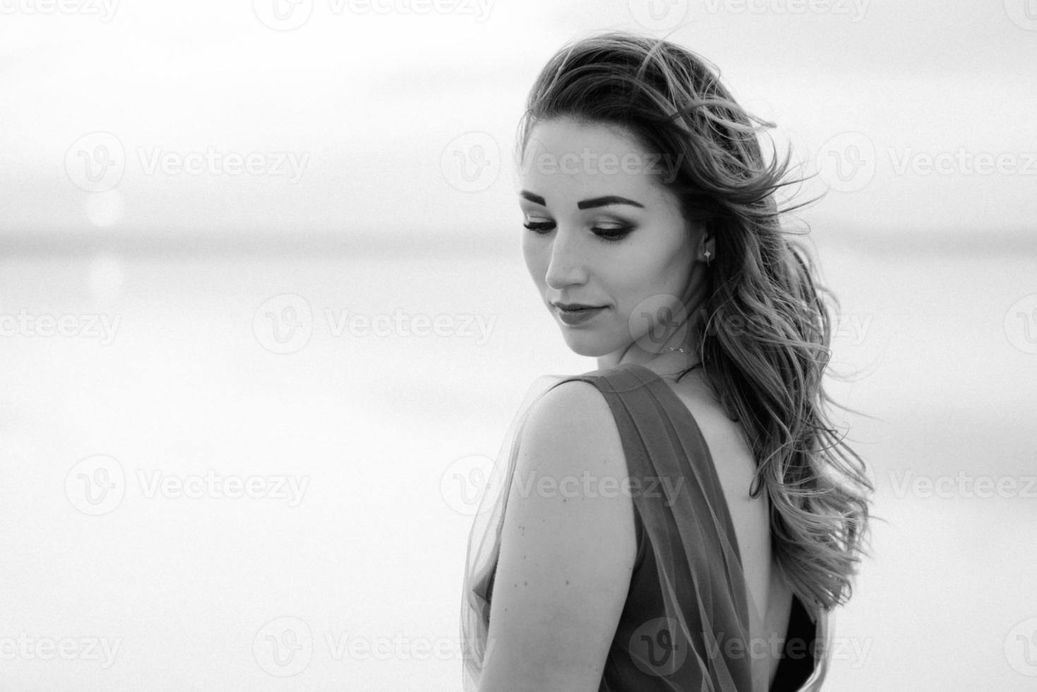 girl on the shore of a pink salt lake photo