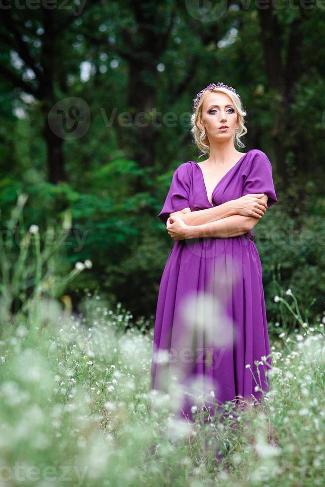 Girl model blonde in a lilac dress with a bouquet photo