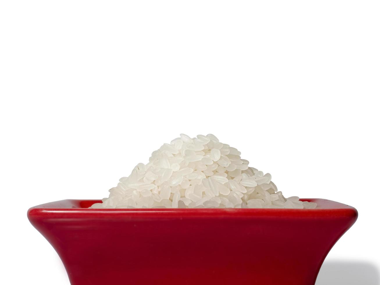 Rice in a red rectangular saucer isolated on white background. Close-up photo