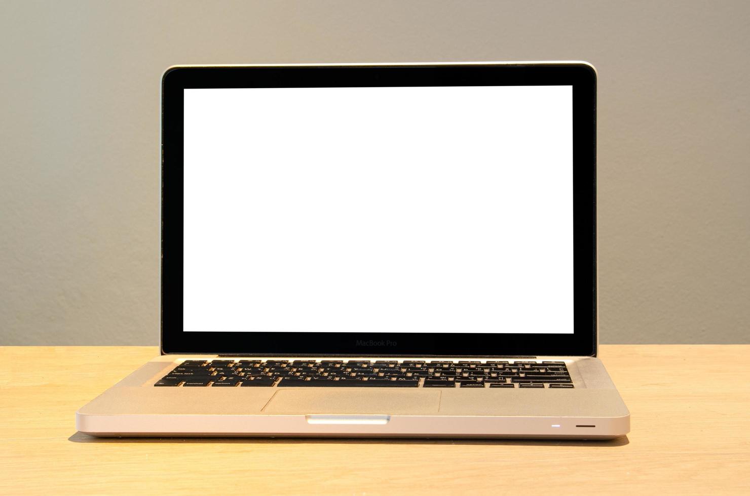 Mockup of a computer laptop on a desk with a blank white screen. photo
