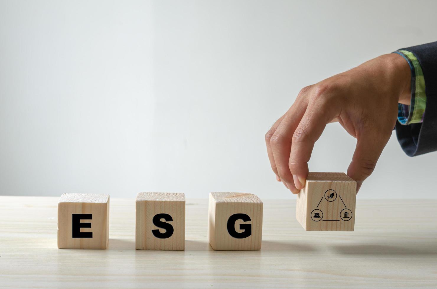 Environmental social and governance ESG investment Organizational growth. Wooden cube  with symbol of esg concept photo