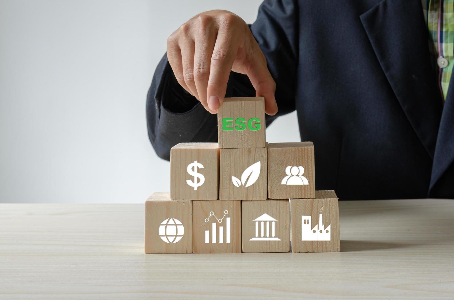 Environmental social and governance ESG investment Organizational growth. Wooden cube  with symbol of esg concept photo