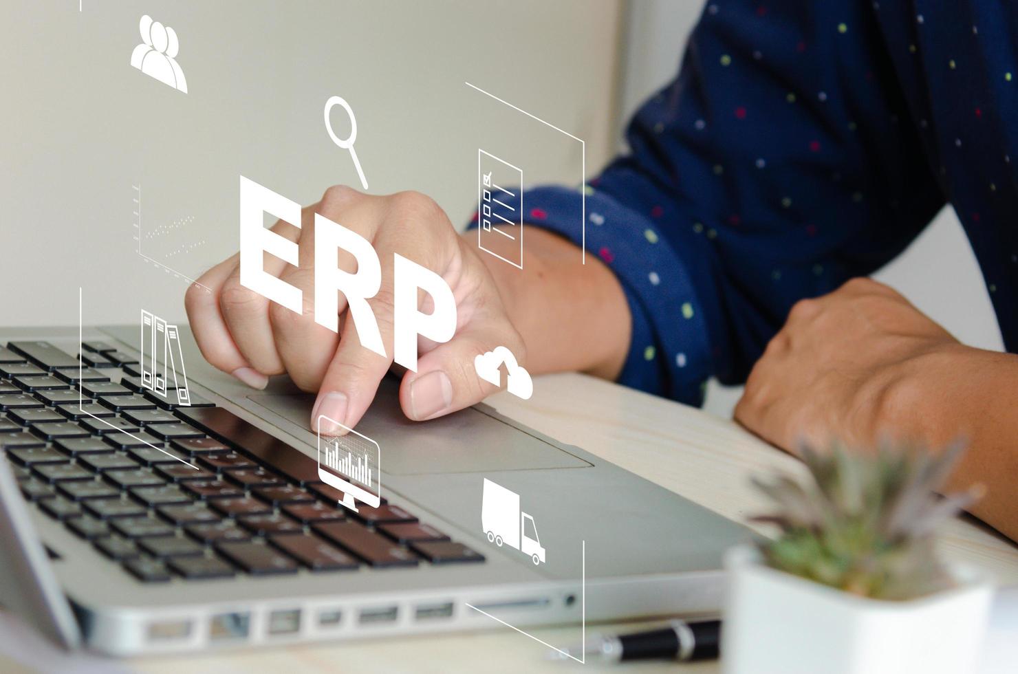 Enterprise Resource Planning EPR Software system for business resource plans. concept hand typing computer laptop icons on virtual screen photo