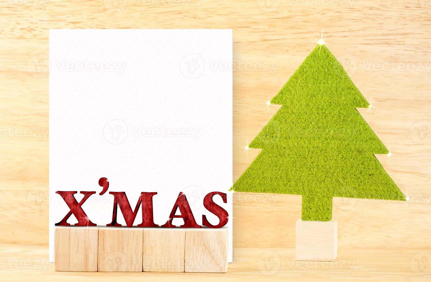 red x'mas word and blank postcard with green christmas tree in room photo