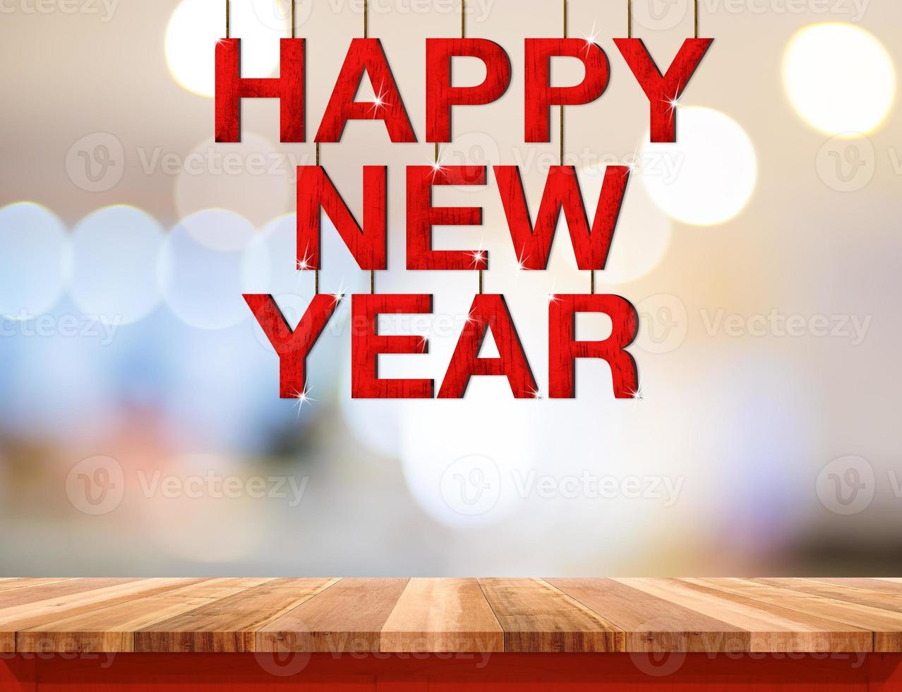 Happy new year red wood word hanging over wood table photo