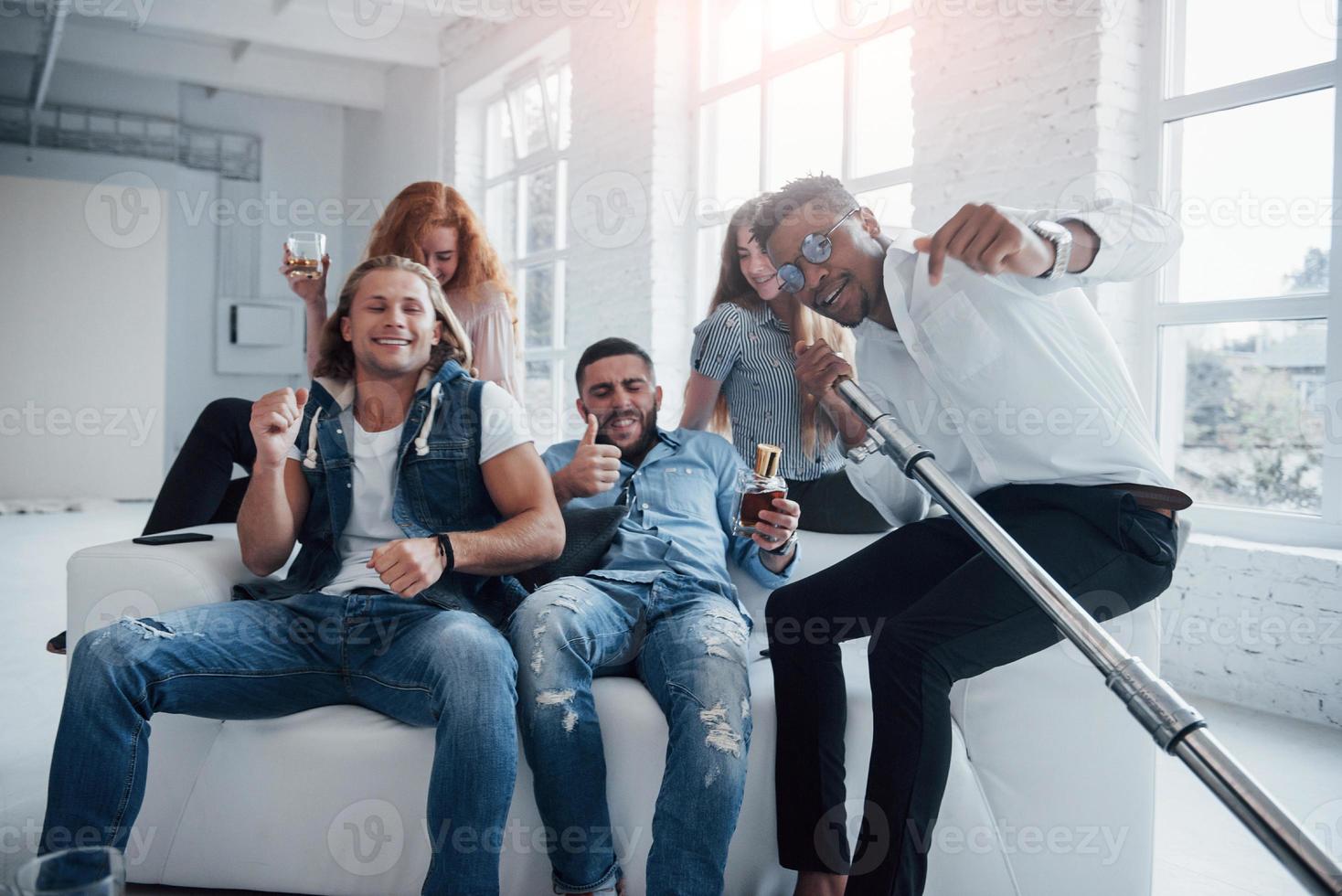 Joyful atmosphere. Friends decides to relax by singing their favourite songs photo