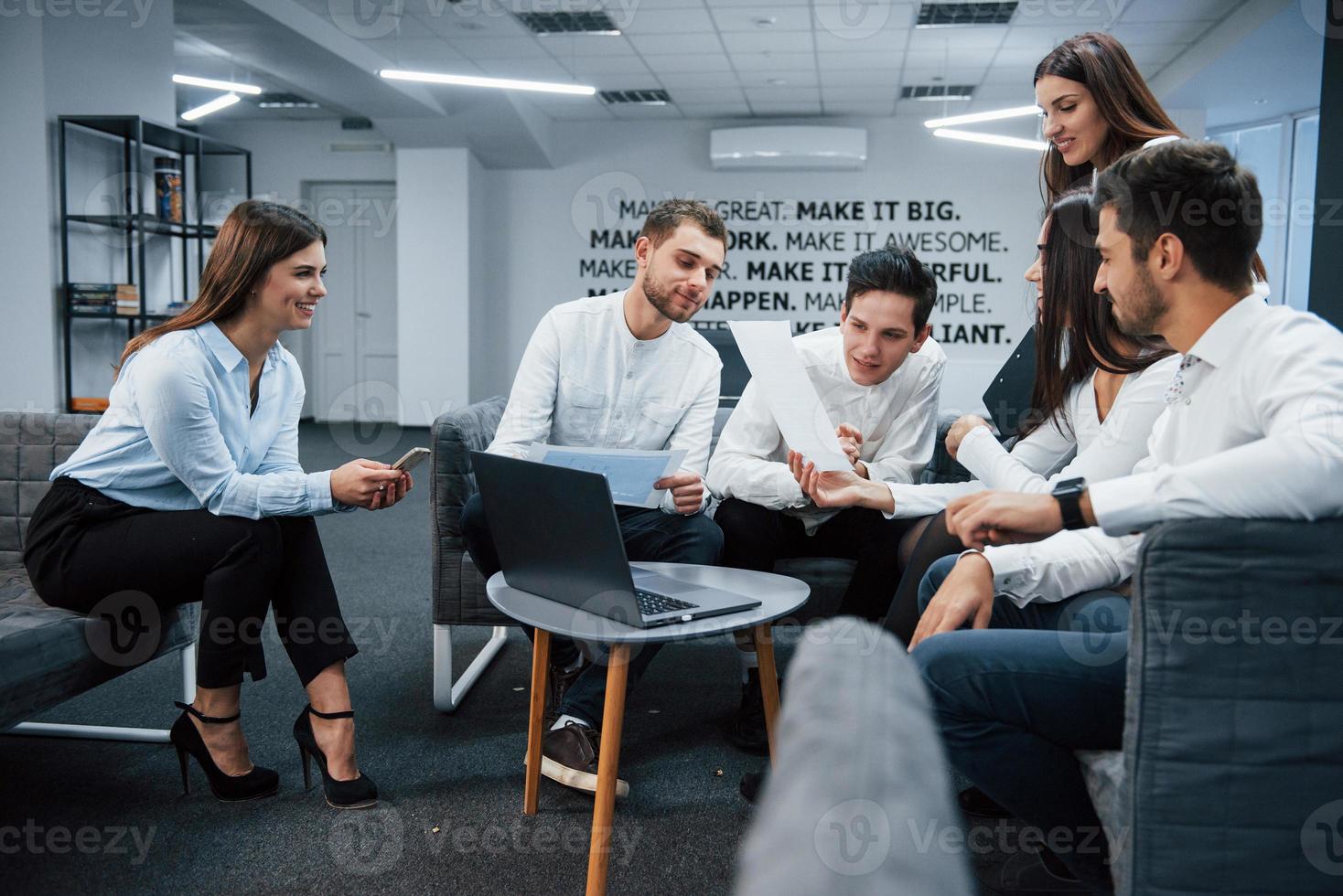 Nice room. Working together in friendly atmosphere using laptop on the table photo