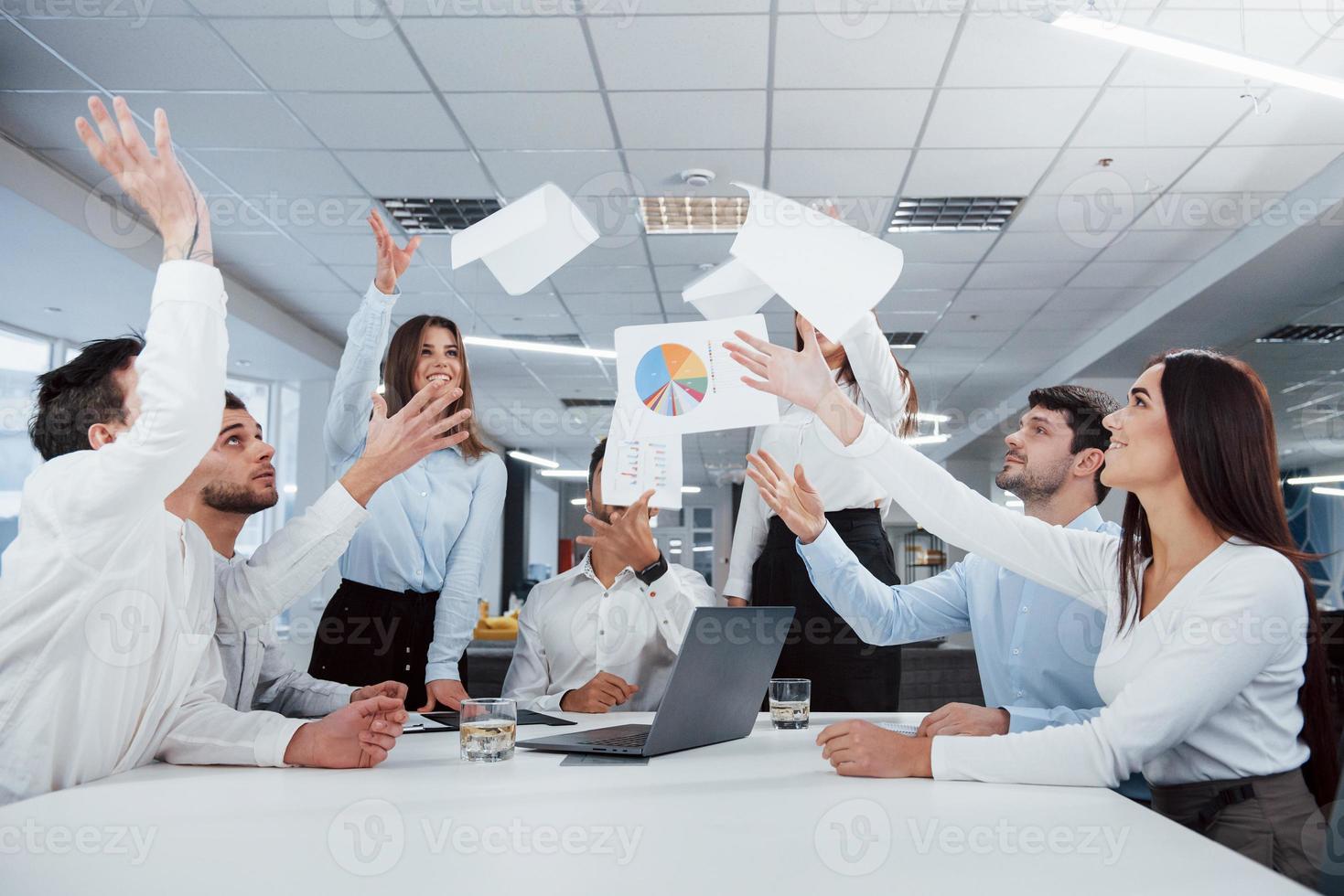 Job is done. Group of office workers happy to hit their own records and being successful photo