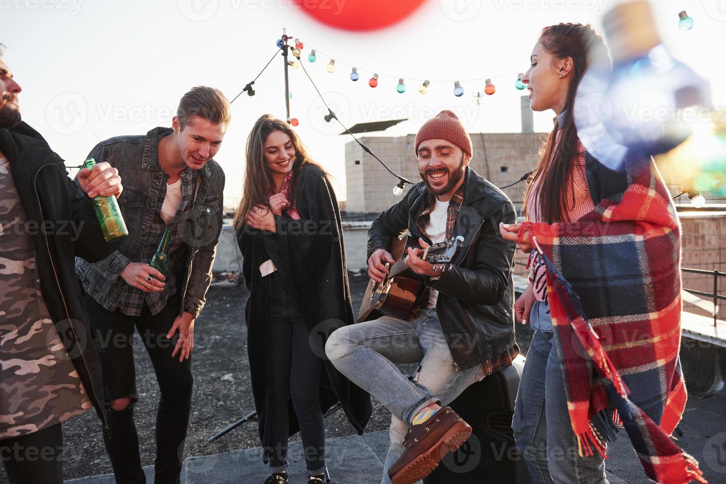 Rate this song. Rooftop party with alcohol and acoustic guitar at sunny autumn day photo