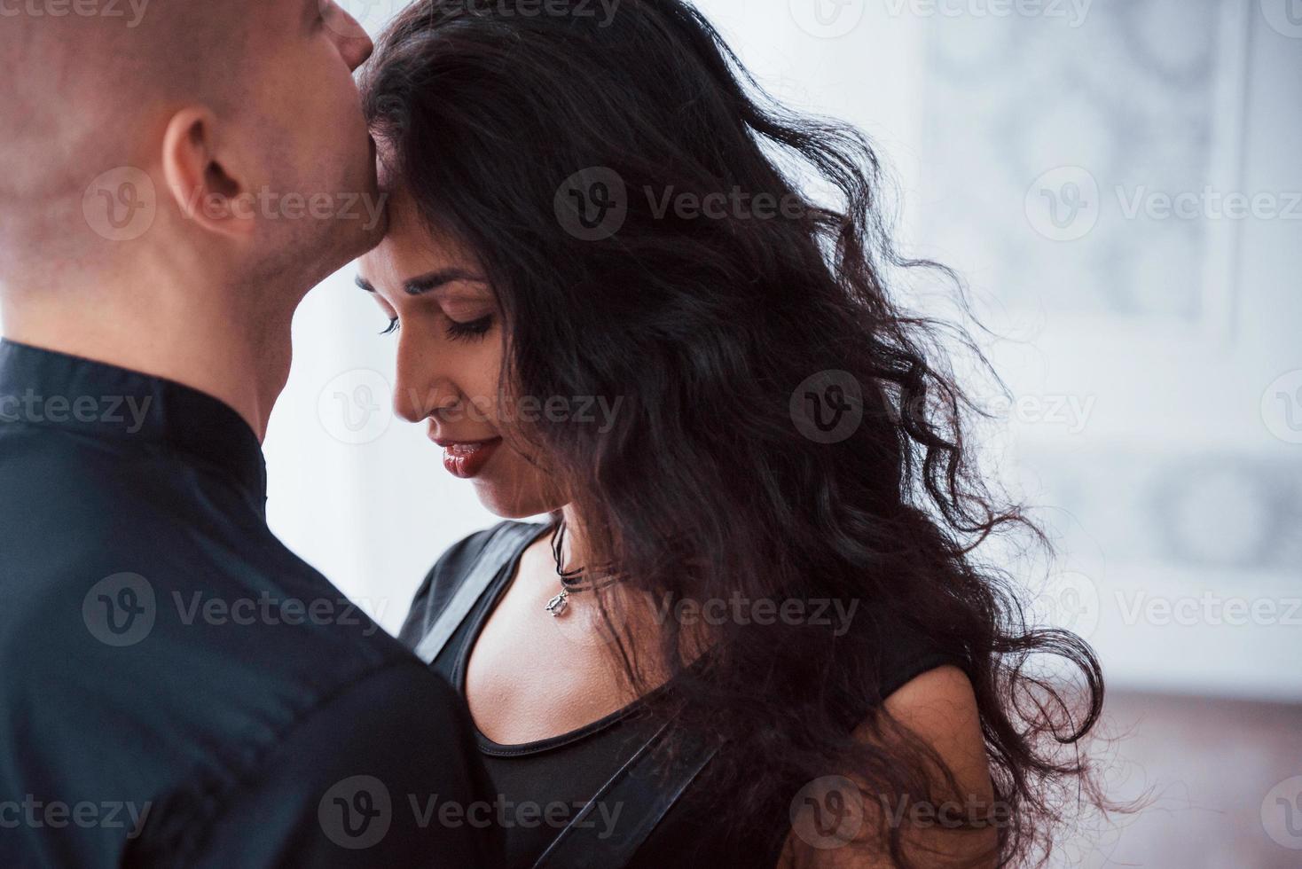 Close up view of beautiful couple. Brunette woman is in love with guy photo