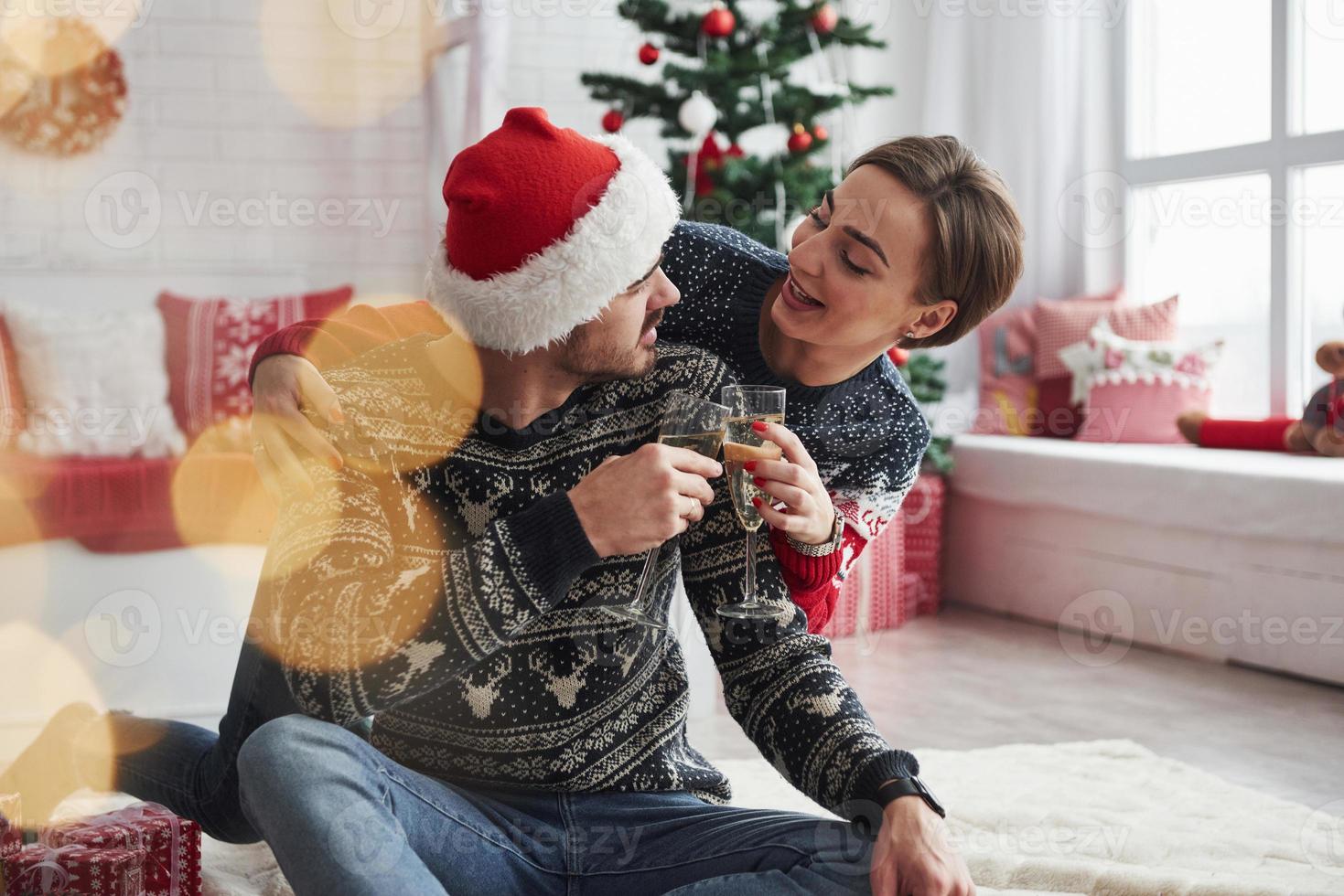 Having fun conversation. Two people sits on the floor and celebrate new year photo