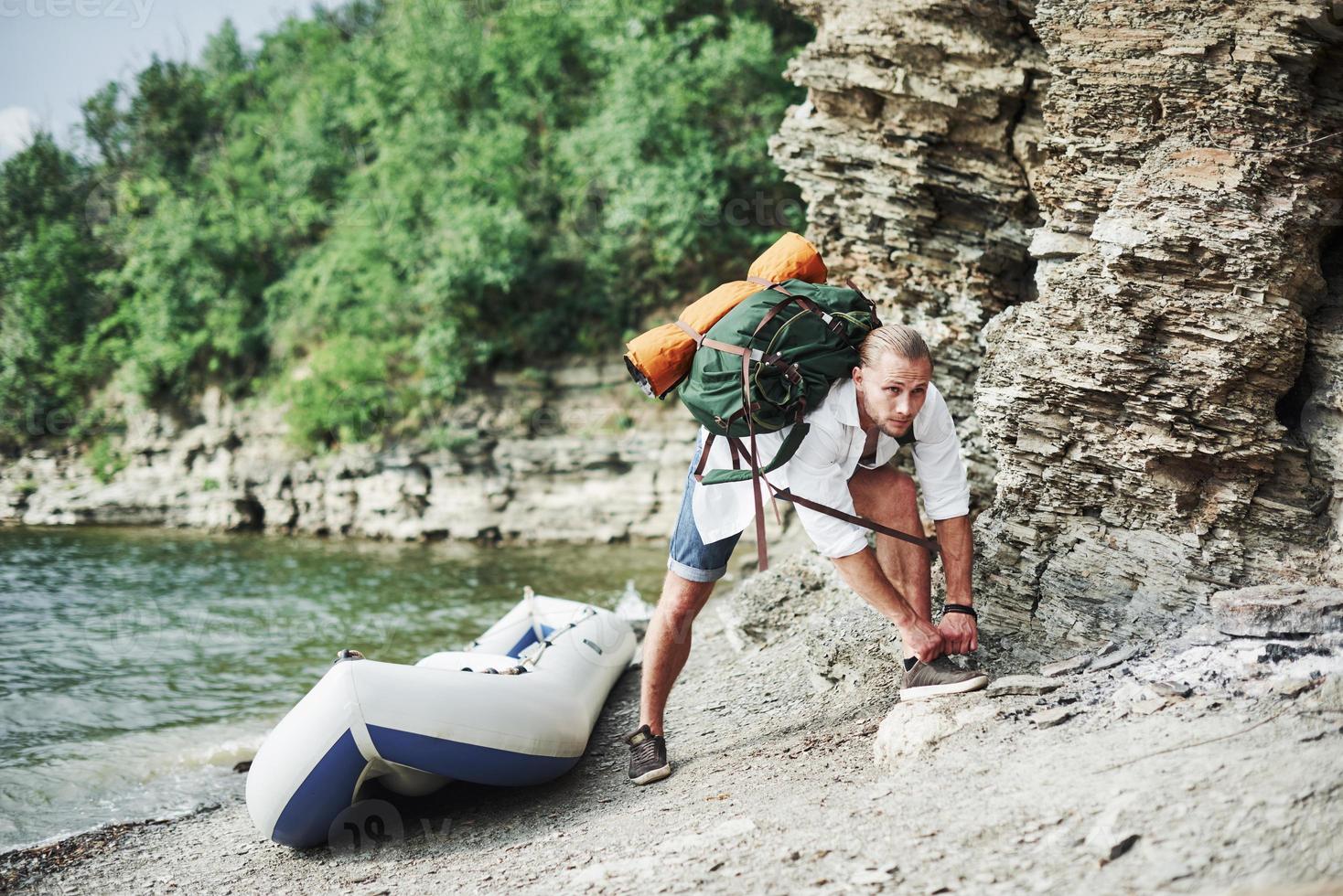 Healthy man is preparing for the hill climbing and new adventures after long travel in the boat photo