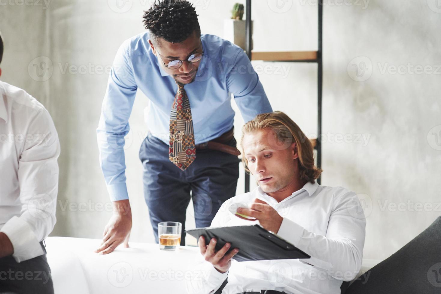 Work in progress in the office with three multiracial employments photo