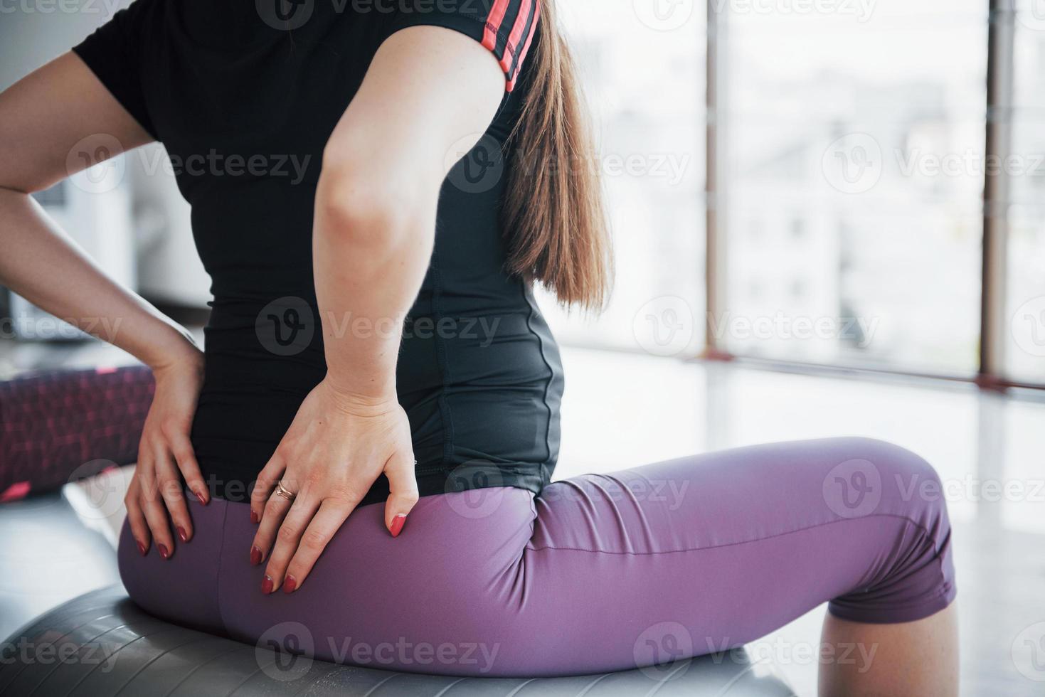 Young pregnant women sitting on the ball for exercises in the gym photo