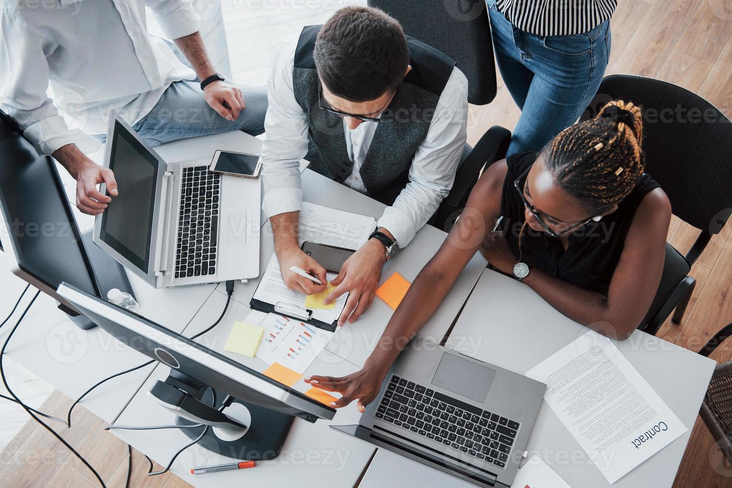 A group of multinational busy people working in the office. photo