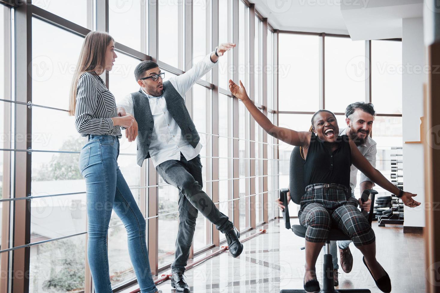 A group of business people having fun, at the office. Celebrate a successful contract. photo