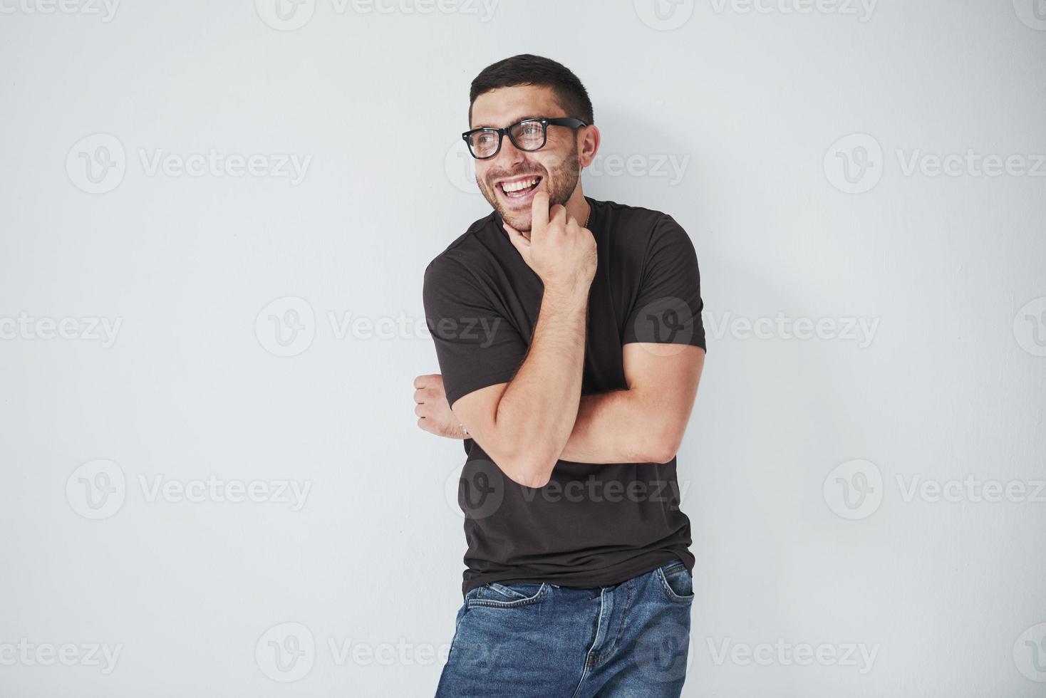 Portrait of a handsome young man thinking on something, isolated on white background. It seems he had a new wonderful idea photo