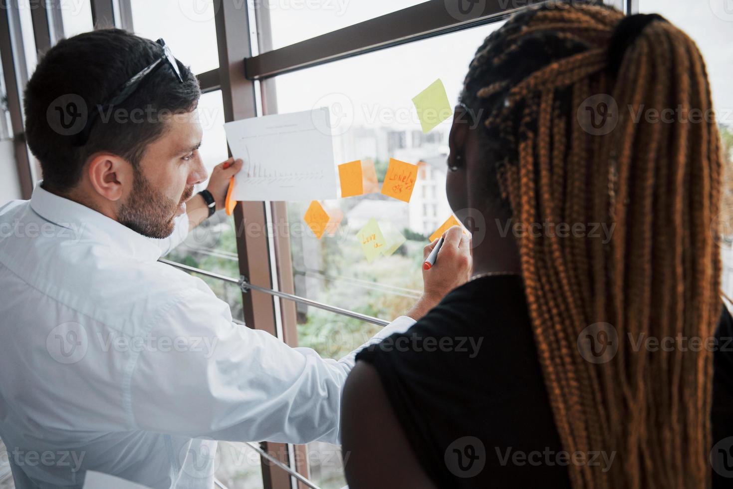 Business presentation in the trendy office of young promising business people photo