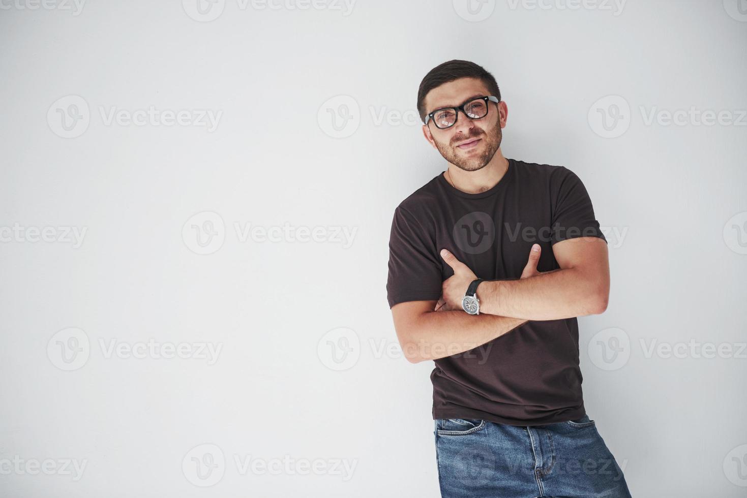 Young hipster guy wearing glasses laughing happily isolated on white background photo