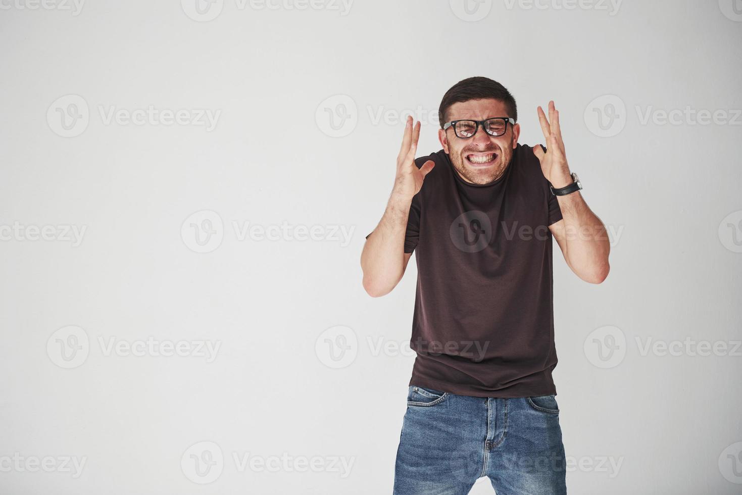 What have I done. The emotional person in casual clothes and in glasses looks as the irreparable mistake is made photo