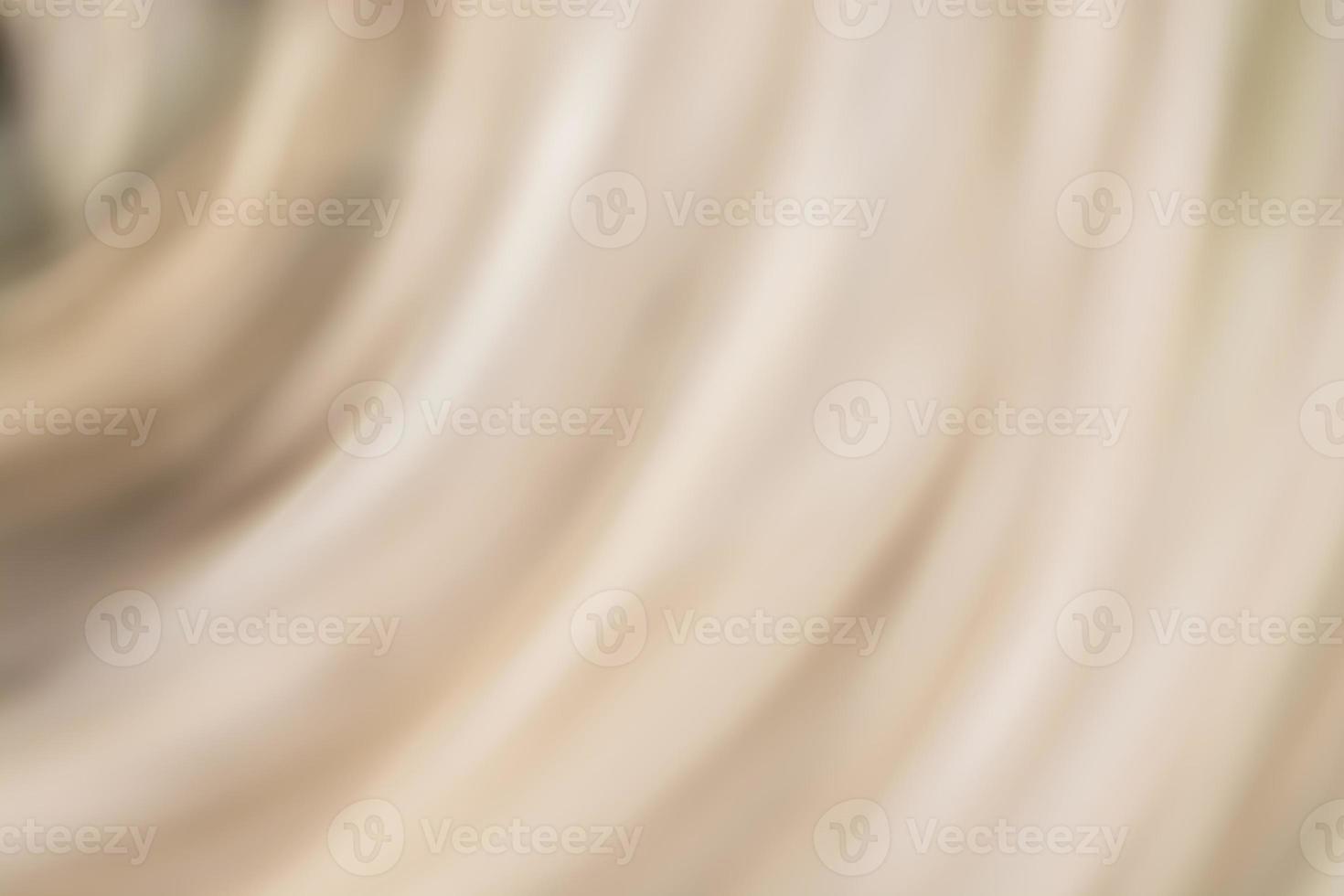 Abstract wavy beige cream silk background. photo