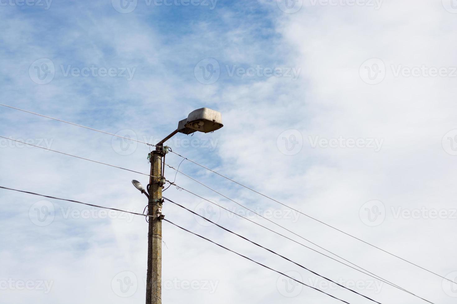 Old city lantern on a background of sky and clouds during the day photo