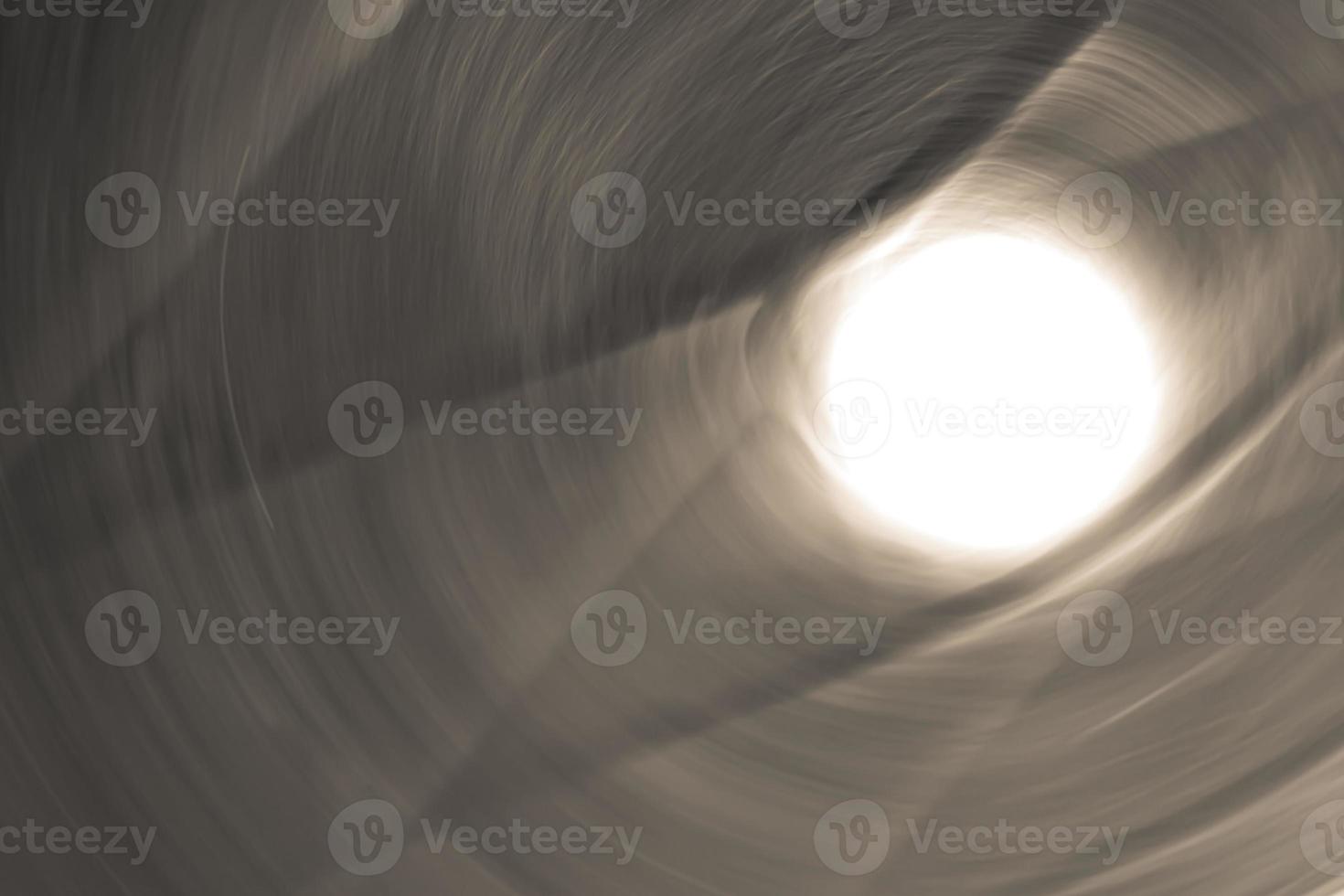 Light at the end of the tunnel. Abstract background in dark brown beige colors. photo