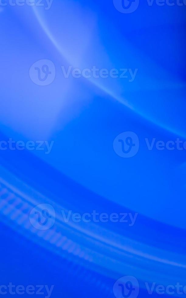 Vertical blue abstract background of curved lines and waves with small highlights. photo