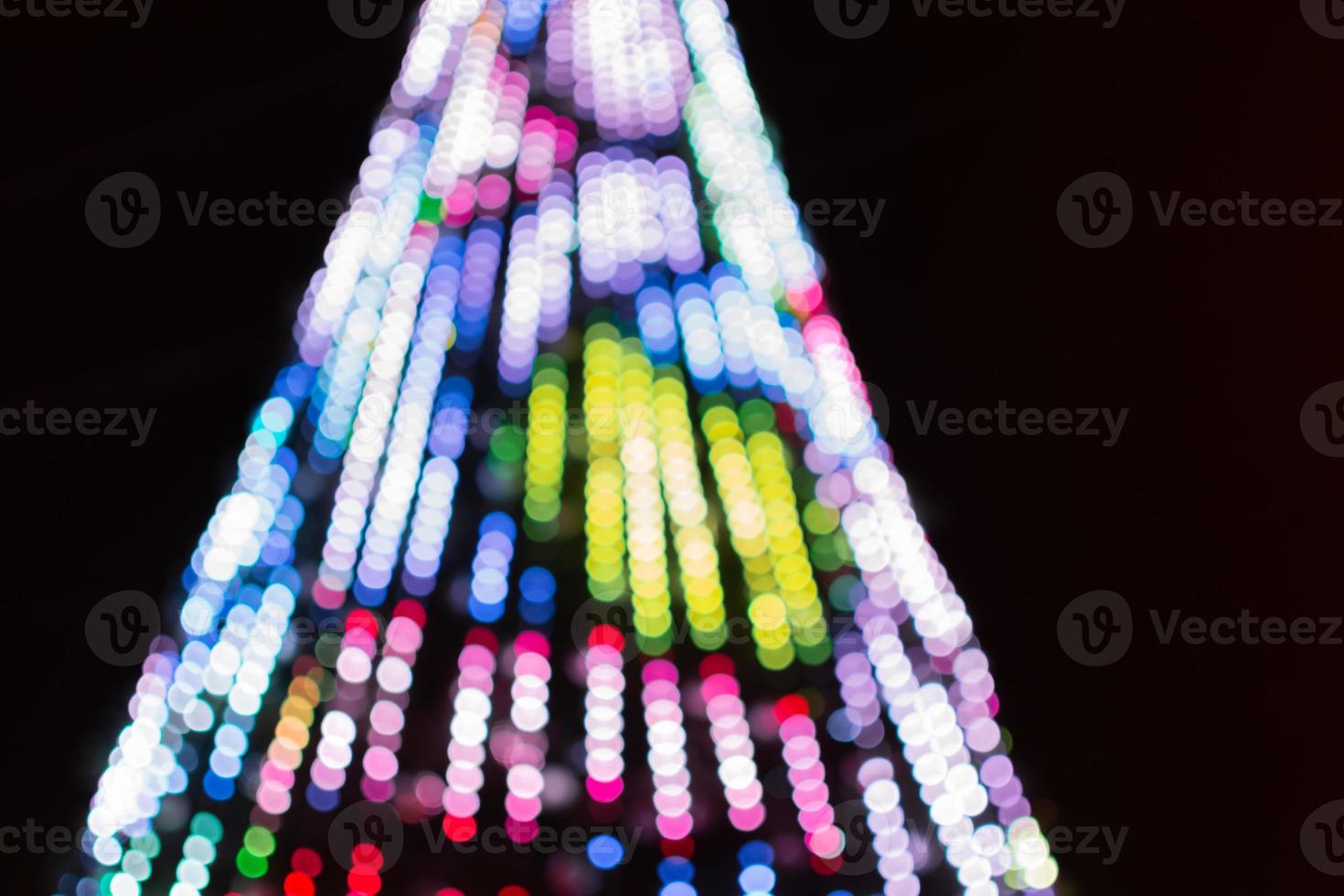 Glare from garlands on the Christmas tree. Soft blur with bokeh photo
