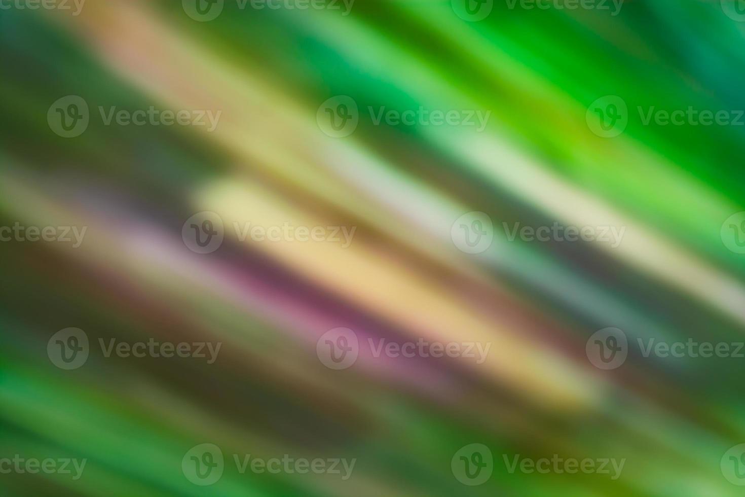Abstract background in green tones with wide ragged diagonal multicolored lines. photo